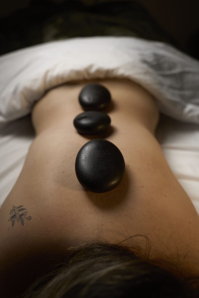 Hot stone massage at Bloor West Retreat in Toronto to deeply relax muscles and relieve stress